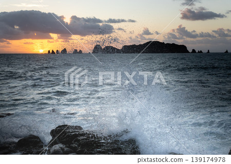 Sunrise and crashing waves off the coast of Nanatsu-iwa in the Hyuga Sea, Nichinan City, Miyazaki Prefecture. Sunrise and crashing waves off the coast of Nanatsu-iwa in the Hyuga Sea, Nichinan City, Miyazaki Prefecture. 139174978