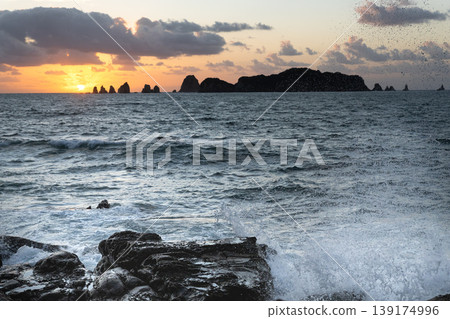 Sunrise and crashing waves off the coast of Nanatsu-iwa in the Hyuga Sea, Nichinan City, Miyazaki Prefecture. 139174996