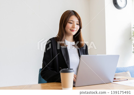 A woman using a computer A woman using a computer 139175491