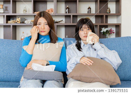 A woman crying while watching a movie A woman crying while watching a movie 139175531