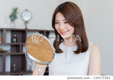 Woman looking in the mirror Woman looking in the mirror 139175565