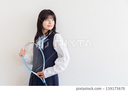 A portrait of a female student holding a tennis racket - an image of sports and youth. A portrait of a female student holding a tennis racket - an image of sports and youth. 139175670