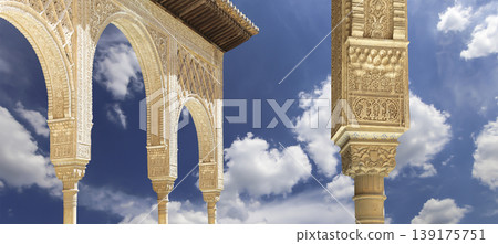 Arches in Islamic (Moorish) style (against the background of a beautiful sky with clouds) in Alhambra, Granada, Spain Arches in Islamic (Moorish) style (against the background of a beautiful sky with clouds) in Alhambra, Granada, Spain 139175751