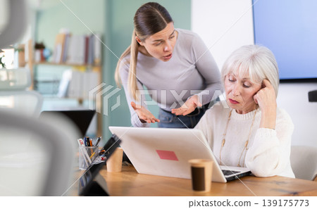 Female boss scolds an mature subordinate for errors in documents Female boss scolds an mature subordinate for errors in documents 139175773