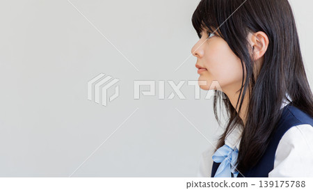 A simple portrait of a female student looking straight ahead in profile. A simple portrait of a female student looking straight ahead in profile. 139175788