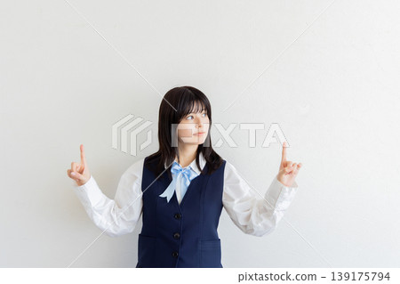 Portrait of a female student pointing with both hands (with space for copy) 139175794