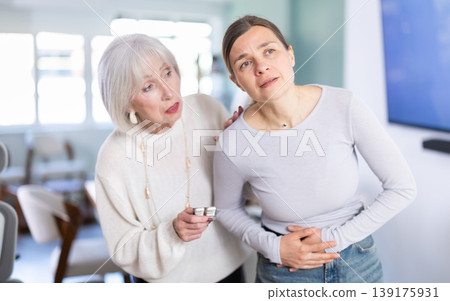 Mature businesswoman offers her colleague abdominal pain pills Mature businesswoman offers her colleague abdominal pain pills 139175931