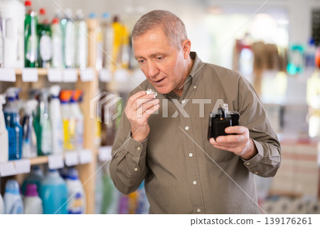 man chooses a perfume in a store 139176261