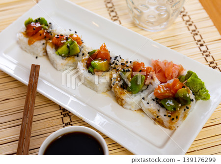 Sushi rolls with crab, cucumber, salmon, avocado seasoned with unagi sauce Sushi rolls with crab, cucumber, salmon, avocado seasoned with unagi sauce 139176299
