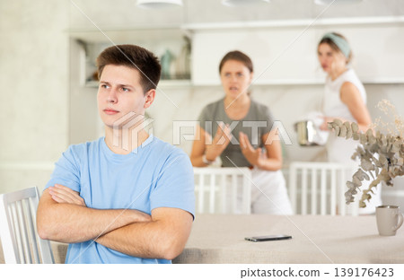 Quarrel of mom, girl and guy. Woman and young girl shouts at guy and accuses her Quarrel of mom, girl and guy. Woman and young girl shouts at guy and accuses her 139176423