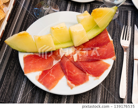 Tasty melon with thin slices of jamon, traditional french dish 139176535