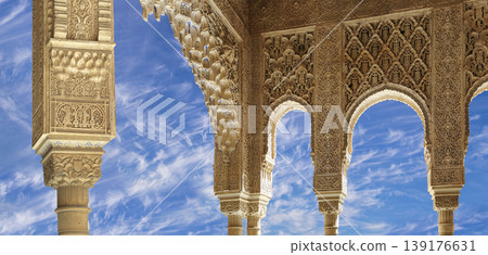 Arches in Islamic (Moorish) style (against the background of a beautiful sky with clouds) in Alhambra, Granada, Spain Arches in Islamic (Moorish) style (against the background of a beautiful sky with clouds) in Alhambra, Granada, Spain 139176631