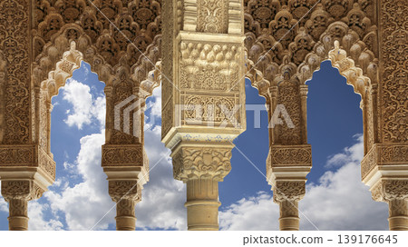 Arches in Islamic (Moorish) style (against the background of a beautiful sky with clouds) in Alhambra, Granada, Spain Arches in Islamic (Moorish) style (against the background of a beautiful sky with clouds) in Alhambra, Granada, Spain 139176645