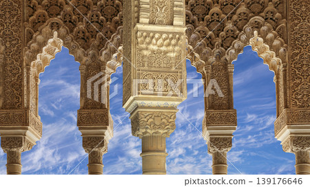 Arches in Islamic (Moorish) style (against the background of a beautiful sky with clouds) in Alhambra, Granada, Spain Arches in Islamic (Moorish) style (against the background of a beautiful sky with clouds) in Alhambra, Granada, Spain 139176646