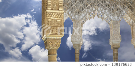 Arches in Islamic (Moorish) style (against the background of a beautiful sky with clouds) in Alhambra, Granada, Spain Arches in Islamic (Moorish) style (against the background of a beautiful sky with clouds) in Alhambra, Granada, Spain 139176653