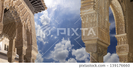 Arches in Islamic (Moorish) style (against the background of a beautiful sky with clouds) in Alhambra, Granada, Spain 139176660