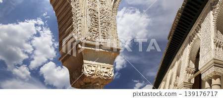 Arches in Islamic (Moorish) style (against the background of a beautiful sky with clouds) in Alhambra, Granada, Spain Arches in Islamic (Moorish) style (against the background of a beautiful sky with clouds) in Alhambra, Granada, Spain 139176717