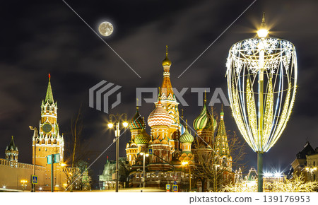 Saint Basil cathedral ( Temple of Basil the Blessed), Spasskaya Tower and Christmas (New Year) decoration, Moscow, Russia. View from Zaryadye Park (at night with the super moon) Saint Basil cathedral ( Temple of Basil the Blessed), Spasskaya Tower and Christmas (New Year) decoration, Moscow, Russia. View from Zaryadye Park (at night with the super moon) 139176953