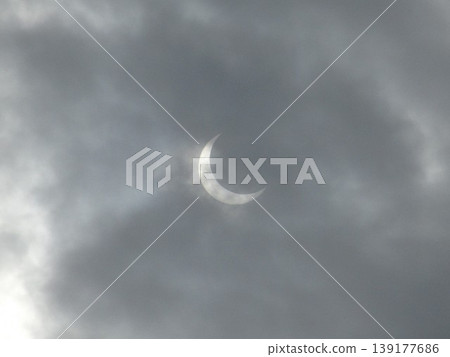 Solar eclipse viewed through the clouds Solar eclipse viewed through the clouds 139177686