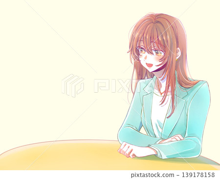 A woman in a suit, smiling, speaks at a desk. 139178158