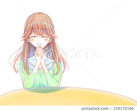 A gentle-looking woman with her hands clasped together at a desk 139178166