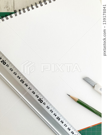 Drafting, design, measurement and cutting, sketchbook on a cutting mat, aluminum ruler and cutter, pencil 139178841