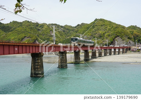 A train crossing a red bridge 139179690