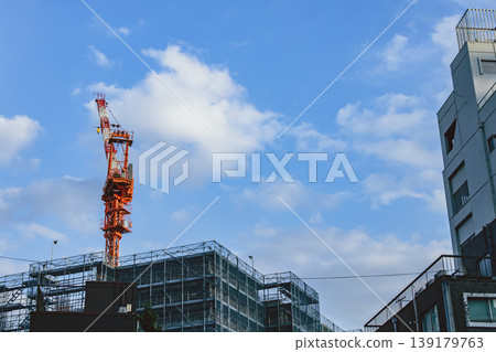 Urban construction with buildings under construction and cranes visible. 139179763