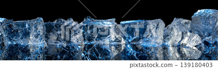 Broken ice with blue backlight on a black reflective background. Broken ice with blue backlight on a black reflective background. 139180403