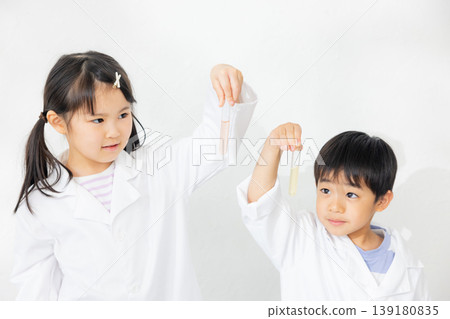 Child holding a test tube 139180835