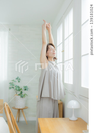 Middle-aged woman by the window Middle-aged woman by the window 139181024