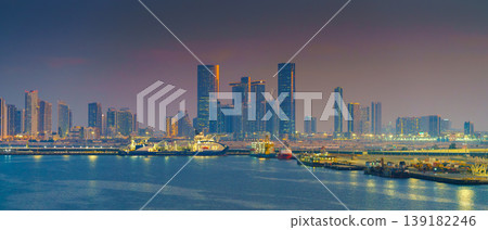 Abu Dhabi, United Arab Emirates - Jan 10 2024, Panoramic view of skyscrapers cityscape with illuminations and street lights on, at sunset, evening, Abu Dhabi, United Arab Emirates Abu Dhabi, United Arab Emirates - Jan 10 2024, Panoramic view of skyscrapers cityscape with illuminations and street lights on, at sunset, evening, Abu Dhabi, United Arab Emirates 139182246