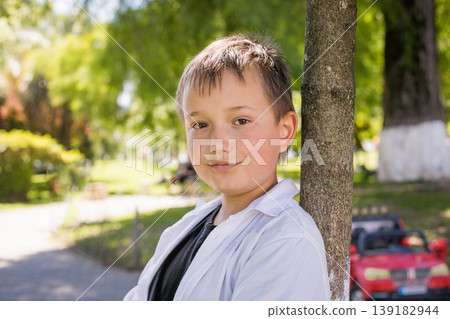 Happy child boy in park outdoors Happy child boy in park outdoors 139182944