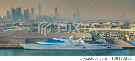 Abu Dhabi, United Arab Emirates - Jan 10 2024, Panoramic view of downtown skyscrapers, in the foreground the port with the moored super yacht YAS in the daytime, Abu Dhabi, United Arab Emirates Abu Dhabi, United Arab Emirates - Jan 10 2024, Panoramic view of downtown skyscrapers, in the foreground the port with the moored super yacht YAS in the daytime, Abu Dhabi, United Arab Emirates 139183231