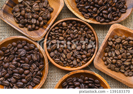 Several types of roasted coffee beans in a wooden bowl Several types of roasted coffee beans in a wooden bowl 139183370