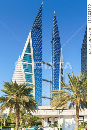 Manama, Bahrain - 08 Jan 2024, a view of World trade Center of Bahrain, with palm trees on foreground, at daytime, Manama, Bahrain  139183450