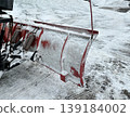 Snow plow clears a path through heavy snow at a parking lot on a winter day 139184002