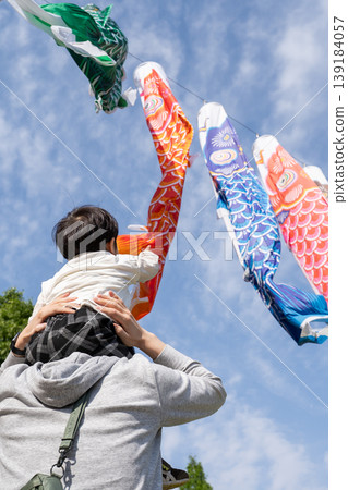 Children looking up at carp streamers Children looking up at carp streamers 139184057