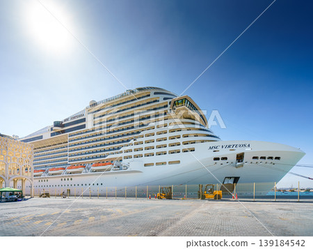 Doha, Qatar - Jan 07 2024, a panoramic view of the MSC Virtuosa cruise ship moored in the port of Doha, in the daytime with the bright sun, Doha, Qatar Doha, Qatar - Jan 07 2024, a panoramic view of the MSC Virtuosa cruise ship moored in the port of Doha, in the daytime with the bright sun, Doha, Qatar 139184542