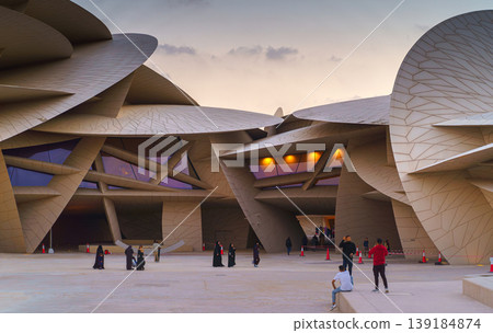 Doha, Qatar - Jan 06 2024, a panoramic view of National Museum of Qatar courtyard, patio, with some people in it, in shape of desert rose, at evening, Doha, Qatar  139184874