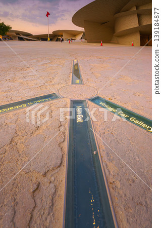 Doha, Qatar - Jan 06 2024, top view of the glass sign located on the floor in the courtyard of the National Museum of Qatar, in the shape of a desert rose, at the evening, Doha, Qatar 139184877