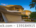 Doha, Qatar - Jan 06 2024, a panoramic view of National Museum of Qatar facade, exterior, shaped like a desert rose, at evening with blue sky, Doha, Qatar  139184915