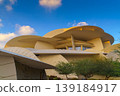 Doha, Qatar - Jan 06 2024, a panoramic view of National Museum of Qatar facade, exterior, shaped like a desert rose, at evening with blue sky, Doha, Qatar  139184917