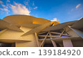 Doha, Qatar - Jan 06 2024, a panoramic view of National Museum of Qatar facade, exterior, shaped like a desert rose, at evening with blue sky, Doha, Qatar  139184920