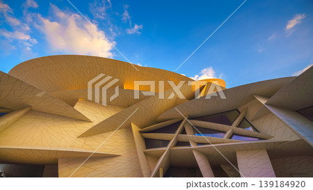 Doha, Qatar - Jan 06 2024, a panoramic view of National Museum of Qatar facade, exterior, shaped like a desert rose, at evening with blue sky, Doha, Qatar  139184920