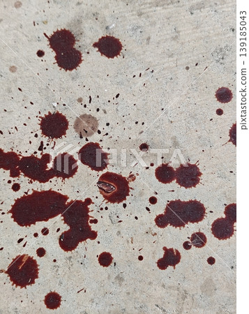 Reddish brown Blood Splatters Across Concrete Surface with Dark Spots Reflecting Brutality and Urgency 139185043