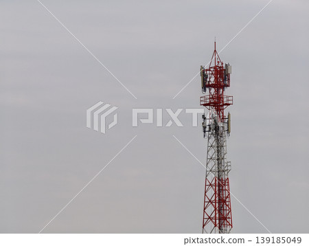 Sturdy Red and Silver Telecommunication Tower Amidst a Hazy Sky A Commercially Applicable Image Sturdy Red and Silver Telecommunication Tower Amidst a Hazy Sky A Commercially Applicable Image 139185049