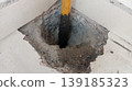 Industrial Hole in Concrete Floor with Yellow Support Pillar 139185323