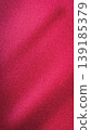 A dramatic abstract background featuring a sweeping light effect contrasting deep crimson red and bold magenta hues. Enhanced with a fashionable grainy noise texture 139185379