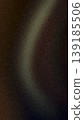 Abstract grainy background featuring a soft curved light beam in gold, olive, and brown tones over a dark charcoal base, perfect for moody, lo-fi modern designs 139185506